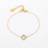 Open klaver armbandje goud met steentjes